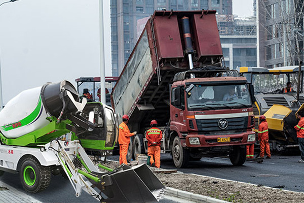 self-loading concrete mixer truck at construction site